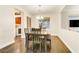 Bright dining room with wood flooring, chandelier, and seating for six at 8017 Flambeau St, Las Vegas, NV 89131