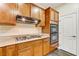 Modern kitchen features gas cooktop, double oven, and wood cabinets at 8017 Flambeau St, Las Vegas, NV 89131