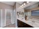 Bathroom features dual sinks, linen closet, and a shower at 8233 San Mateo St, North Las Vegas, NV 89085