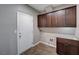 Laundry room with ample cabinetry and wood-look flooring at 8233 San Mateo St, North Las Vegas, NV 89085