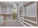 Spacious walk-in closet with built-in shelves and rods at 8233 San Mateo St, North Las Vegas, NV 89085