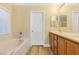 Bathroom with soaking tub, double vanity, and wood-look floors at 9039 Last Hope Ave, Las Vegas, NV 89178