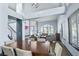 Dining room with a wooden table, chairs, and large windows providing natural light at 9709 Terrace Green Ave, Las Vegas, NV 89117