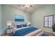 Main bedroom with light blue walls, wood-look flooring, and a ceiling fan at 1052 Hollyhock Dr, Henderson, NV 89011