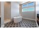 Luxurious bathroom with freestanding tub and patterned tile floor at 140 Tre Pietre St, Henderson, NV 89011