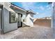 Small backyard patio with gray stone wall and paver stones at 140 Tre Pietre St, Henderson, NV 89011