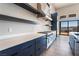 Modern kitchen with stainless steel range hood and white quartz countertops at 140 Tre Pietre St, Henderson, NV 89011