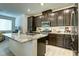 Modern kitchen with granite countertops and dark wood cabinets at 20 Barbara Ln # 20, Las Vegas, NV 89183