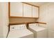 Laundry room with washer, dryer, cabinets, and utility sink at 2100 Desert Peak Rd, Las Vegas, NV 89134