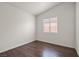 Empty bedroom with dark wood-look laminate floors and large window at 2105 Marathon Keys Ave, North Las Vegas, NV 89031