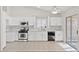 Bright kitchen featuring white cabinetry, stainless steel appliances, and tile flooring at 2105 Marathon Keys Ave, North Las Vegas, NV 89031