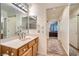 Clean bathroom with a vanity, large mirror, and access to hallway at 2736 Desert Crystal Dr, Las Vegas, NV 89134