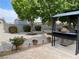 Large backyard with gravel, mature trees, and a built-in BBQ at 5200 Wheatland Dr, Pahrump, NV 89061