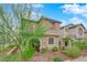 Two-story house with tan exterior, landscaping, and a walkway to the entrance at 8042 Mercury Skye St, Las Vegas, NV 89166