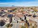 Aerial view of a house with solar panels and a neighborhood in the background at 852 Bussora Rose Dr, Henderson, NV 89015