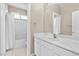 Bright bathroom featuring a white vanity and bathtub at 852 Bussora Rose Dr, Henderson, NV 89015