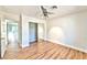 Bright bedroom with mirrored closet doors and wood-look floors at 8913 Stoney Point Dr, Las Vegas, NV 89134