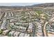 Aerial view of a luxury residential community with numerous homes and mountain views at 10 Moonfire Dr, Las Vegas, NV 89135