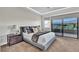 Bright bedroom with a plush bed and access to a balcony at 10 Moonfire Dr, Las Vegas, NV 89135