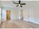 Bright bedroom with wood-look floors, ceiling fan, and ample closet space at 10810 Porto Foxi St, Las Vegas, NV 89141