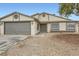 Newly remodeled beige house with gray garage doors at 1269 Jarbridge Rd, Las Vegas, NV 89110