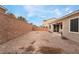 Backyard view, gravel, block wall, and patio area at 1273 Olivia Pkwy, Henderson, NV 89011