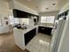 Galley kitchen with dark cabinets, white appliances and tile countertops at 2153 Camel Mesa Dr, Laughlin, NV 89029