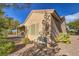 Tan house exterior with covered patio and desert landscaping at 2183 Cumberland Hill Dr, Henderson, NV 89052