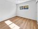 Well-lit bedroom featuring light hardwood floors and a large window at 281 E Chaparral Dr, Henderson, NV 89015