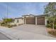 Tan two-story house with a brown double garage at 324 S Lisbon St, Henderson, NV 89015