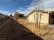 Backyard view of house with gravel and small trees at 4671 Petaluma Cir, Las Vegas, NV 89120