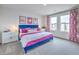 Main bedroom with a plush bed and pink accents at 4854 Currant Ridge Ave # 67, Las Vegas, NV 89141