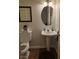 Clean and well-lit half bathroom with pedestal sink at 5901 Enchanted Palms Ave, Las Vegas, NV 89139