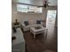 Living room with hardwood floors, white sofa, and a coffee table at 5901 Enchanted Palms Ave, Las Vegas, NV 89139