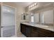 Double vanity bathroom with granite countertop and dark brown cabinets at 6144 Scarlet Leaf St, Las Vegas, NV 89148