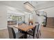 Open concept dining room with a wooden table and stairs visible in the background at 7 Summit Walk Trl, Henderson, NV 89052