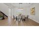 Bright dining room features a large wooden table, chandelier, and hardwood floors at 7 Summit Walk Trl, Henderson, NV 89052