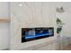 Modern electric fireplace with marble surround and floating shelves at 7 Summit Walk Trl, Henderson, NV 89052