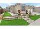 Landscaped front yard with artificial turf and stone pathway leading to the house entrance at 963 Mill Run Creek Ave, Henderson, NV 89002