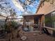 Covered patio, storage shed, and gravel backyard with mature plants at 10171 Arlington Abby St, Las Vegas, NV 89183