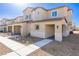 Tan two-story home with attached garage and walkway at 10778 Purdy Ct, Las Vegas, NV 89166