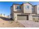 Two-story home with attached garage and brick driveway at 10778 Purdy Ct, Las Vegas, NV 89166