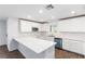 Modern kitchen with white cabinets and expansive island at 10778 Purdy Ct, Las Vegas, NV 89166