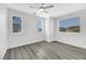 Bedroom with two windows, ceiling fan and wood-look floors at 11918 Giles St, Las Vegas, NV 89183