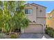 Two-story house with tan siding, a two-car garage, and mature landscaping at 151 Duckhook Ave, Las Vegas, NV 89148