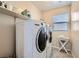 Bright laundry room with washer, dryer, and shelving at 151 Duckhook Ave, Las Vegas, NV 89148