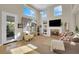 Cozy living room with a fireplace, built-in shelves, and large windows at 2336 Tilden Way, Henderson, NV 89074