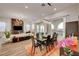 Open concept dining room with large table, hardwood floors, and modern lighting at 26 Costa Tropical Dr, Henderson, NV 89011