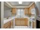 Kitchen with light wood cabinets, white appliances, and tile countertops at 2725 S Nellis Blvd # 2022, Las Vegas, NV 89121