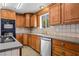 Kitchen with wood cabinets, tile countertops, and appliances at 2925 Rice St, Logandale, NV 89021